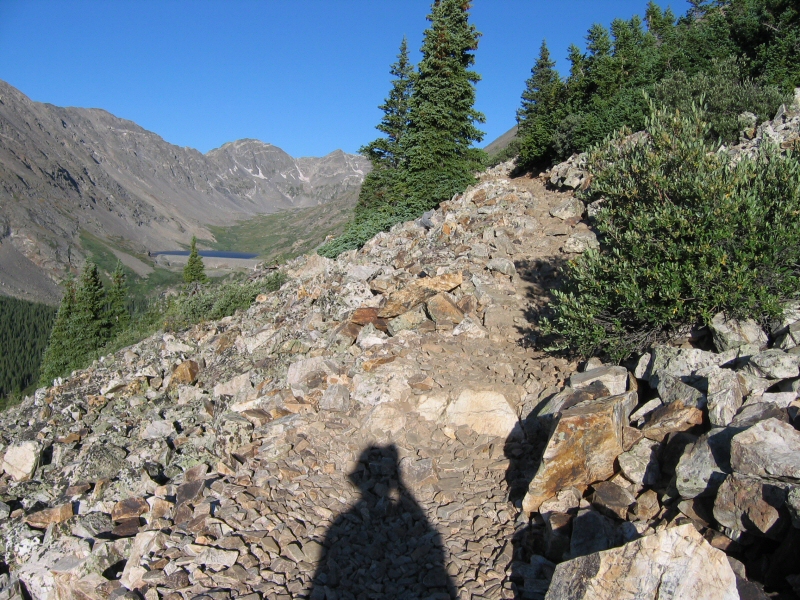 For most of the rest of this hike, the trail is rocky.  Off in the distance to the west-southwest is Wheeler Mountain (elevation 13,690 feet).