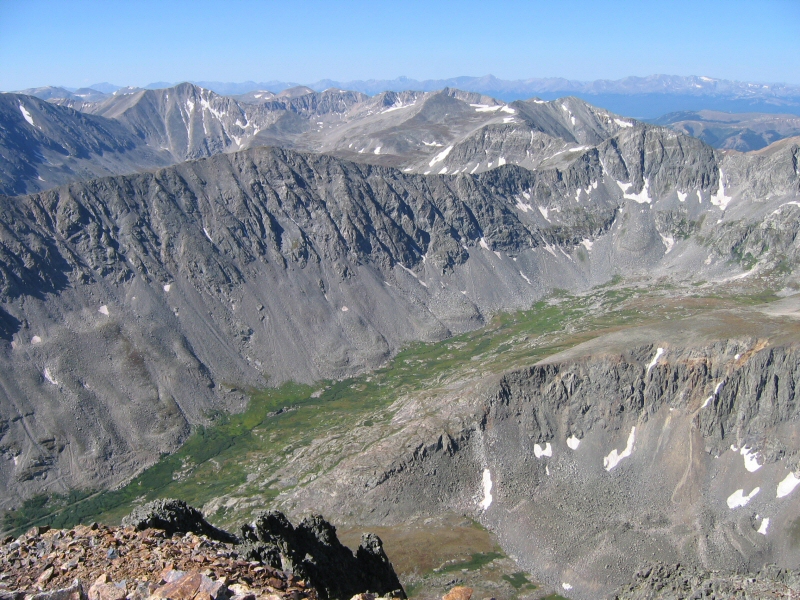 Southwest beyond the ridge of North Star Mountain in the foreground is, from left to right, the shoulder of Mount Democrat, Mount Buckskin, a distant Treasurevault Mountain, no-name summit (at 13,672 feet), and Mount Arkansas (elevation 13,795 feet).  Beyond that is the town of Leadville, Colorado and the line of peaks making up the horizon includes from right to left, Mount Massive, Mount Elbert, La Plata Peak and other mountains in the Collegiate Peaks Range.