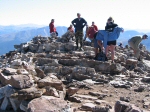 It's kind of crowded here on the summit.  Notice people putting on additional clothes to stay warm in the stiff wind.