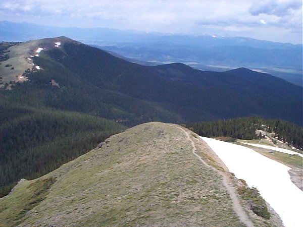 A view of the trail as it follows the ridge back down.  [Note: if you click through to the larger image you may be able to notice the road to the trailhead hidden in the trees just to the left of the knob near the middle of the image.]