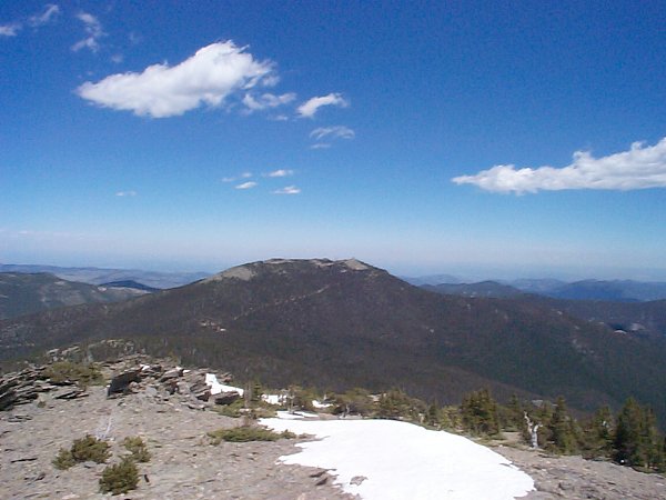 Squaw Mountain (el. 11,486) is easily viewed in its entirety just east of Chief Mountain with the flats of Denver (Kansas?) visible beyond to the horizon.