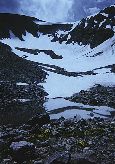 The snowfield at the head of the valley between the peaks.