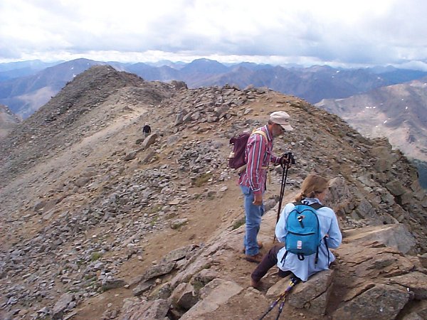 Upon arrival, there were several people on the summit.  Although it wasn't planned, the hike turned into a loop hike rather than an out-and-back.  For weather reasons, the path followed the gentleman in the background (black dot, left center) down a couloir on back side of the mountain so as to quickly lose elevation.