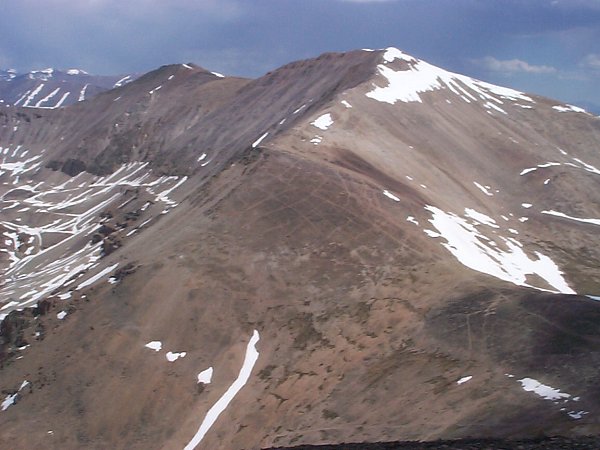 About 1.4 miles northeast of the summit of Mount Sheridan lies the summit of Mount Sherman (14,036 feet).  Note the trail scars on the southwest face of Sherman.