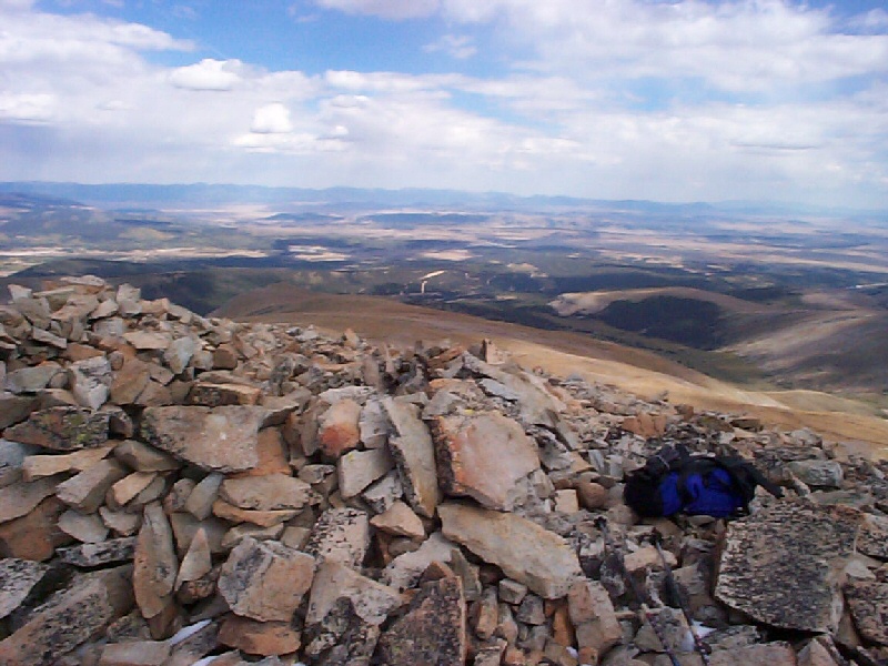 My backpack sitting next to one of the many rock structures on the summit of Mount Sherman.