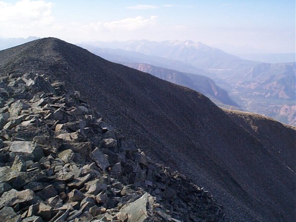 Looking back on the summit of West Mount Sopris with Chair Mountain on the horizon.