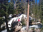 Kaye watching the water go by.  Note that the trail on the far side of the bridge is completely covered with snow.