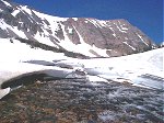 A snowfield erroded by the rushing water.