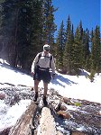 Bernie crossing a log bridge at high water.