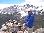 Mike on the summit admiring the view of the Twin Sisters with Long's Peak in the background.