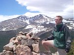 Steve on the summit admiring the view of the Twin Sisters with Long's Peak in the background.