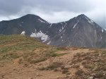 I had to walk around this goat to get to the summit.  Grays Peak and Torreys Peak provide the backdrop.