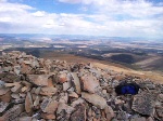 My backpack sitting next to one of the many rock structures on the summit of Mount Sherman.