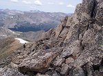 Hikers head back down through the rocks to the ridge to the saddle at around 13,500 feet.